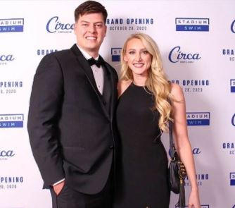 Stormy Buonantony and her husband Christopher Normandt standing close to each other and smiling at the camera.