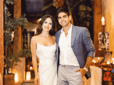 Adria Arjona smiling with her ex-husband while sharing a side hug.