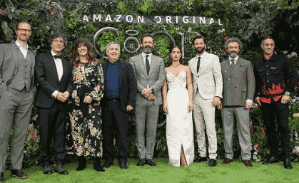 Adria Arjona posing with the cast of Good Omens, all standing and looking at the camera.