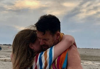 Lloyd Owen and his Spouse Juliette Mole hugging each other.