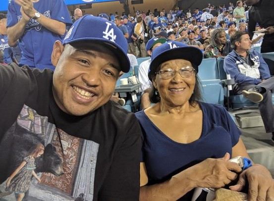 Omer Benson Miller with his mother watching Doggers.