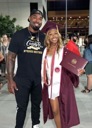 tyron-smith-with-his-youngest-sister Tyron Smith with his youngest sister Tamia Pinkney at her graduation