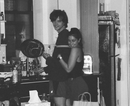 Black and white photo of Christopher Briney girlfriend Isabel Machado hugging him from back.