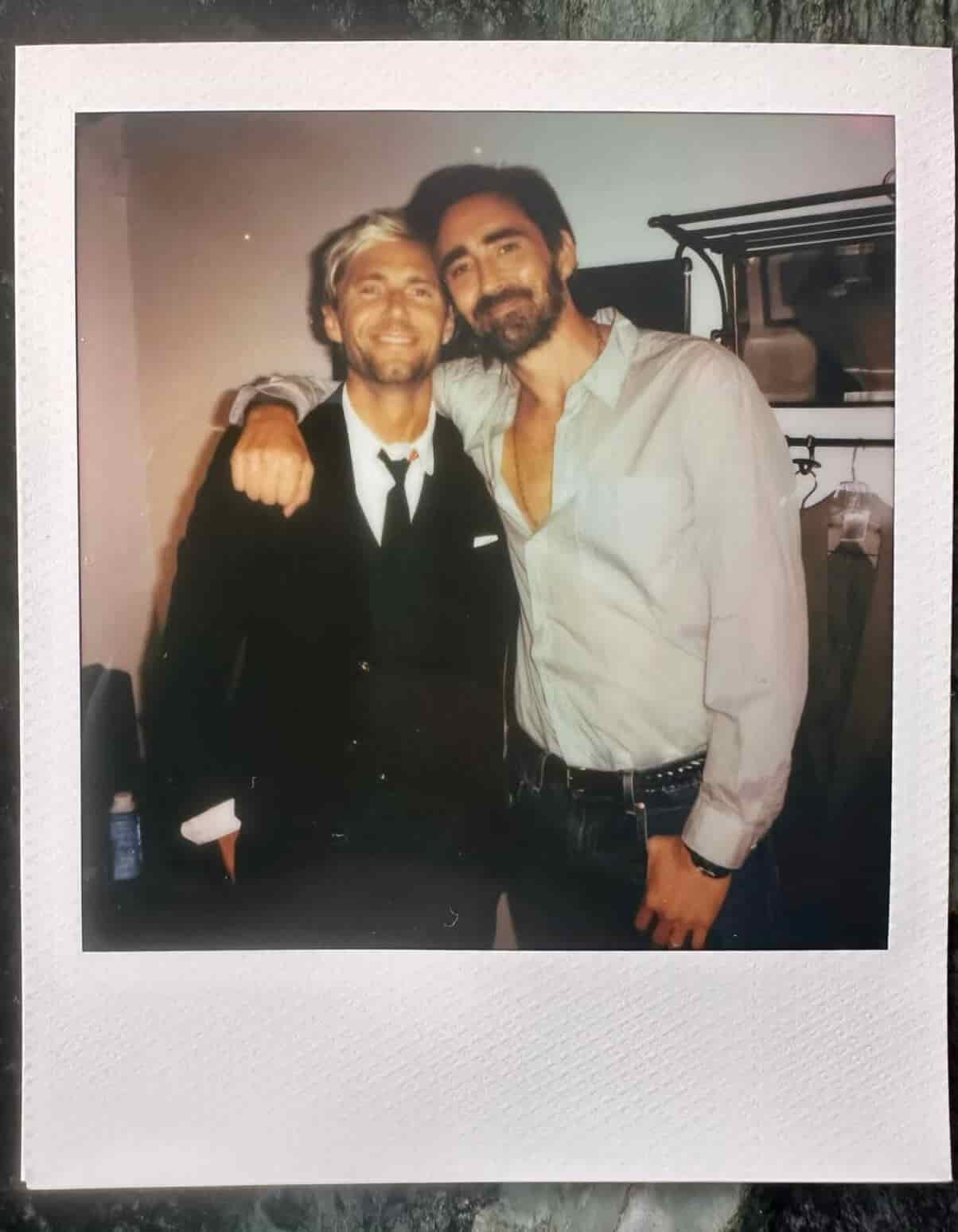 Lee Pace with his husband, Matthew Foley, sharing a side hug.
