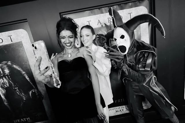 A black and white photo of Avantika Vandanapu taking a selfie with two co-stars from the film Tarot.