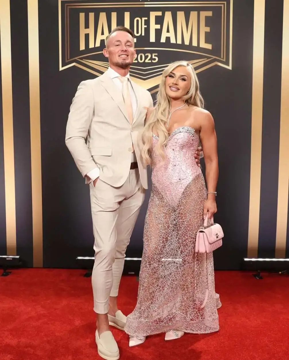 Professional wrestler Ludwig Kaiser and his girlfriend Tiffany Stratton pose for a photo together at a Hall of Fame event.