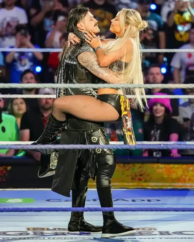 Liv Morgan and a man embrace in a wrestling ring, with Morgan