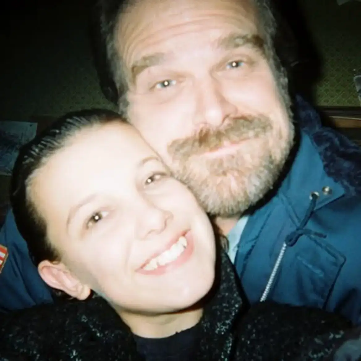 Selfie of Millie Bobby Brown and David Harbour smiling at the camera.
