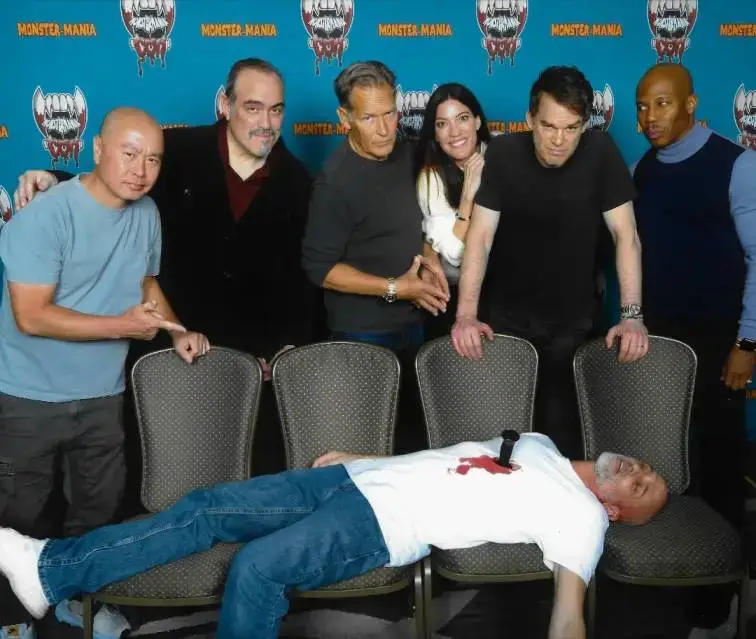 Actor James Remar poses with the cast of the television series Dexter behind a prop victim at a Monster-Mania Con fan event.