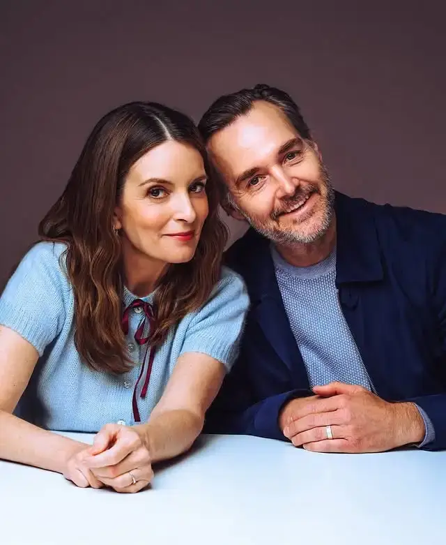 Actors Tina Fey and Will Forte smile while posing together at a 2025 press event for their Netflix series The Four Seasons.