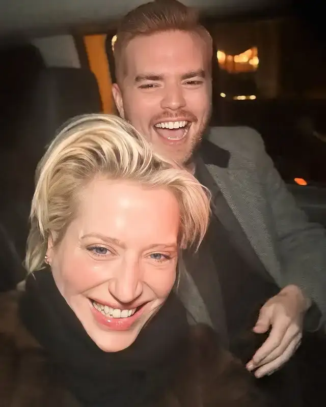 Dorinda Medley and Tim Cush smile and laugh while sitting in the backseat of a vehicle.