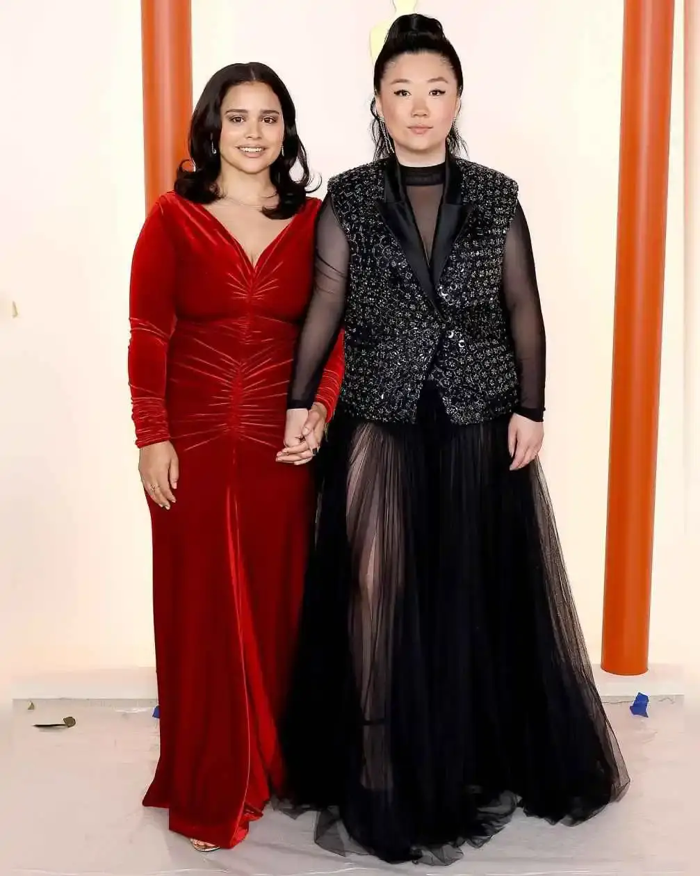 Marisela Zumbado and her partner Sherry Cola hold hands while posing on the red carpet at the Bride Hard premiere in Los Angeles.