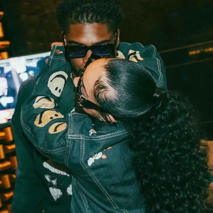 Trevon Diggs wearing sunglasses and a denim jacket while embracing Joie Chavis.