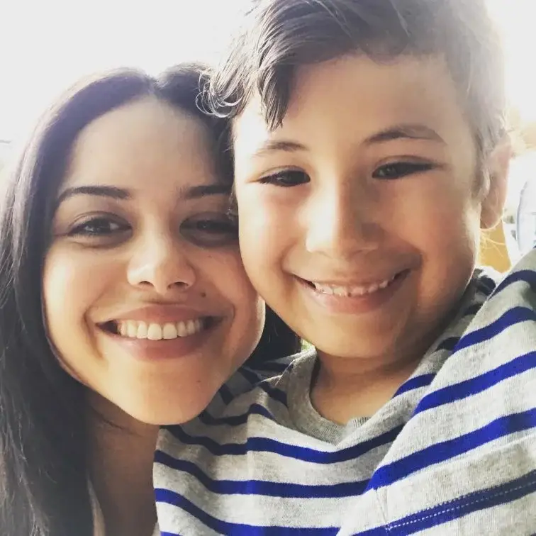 Actress Alyssa Diaz smiles warmly while posing beside her son.