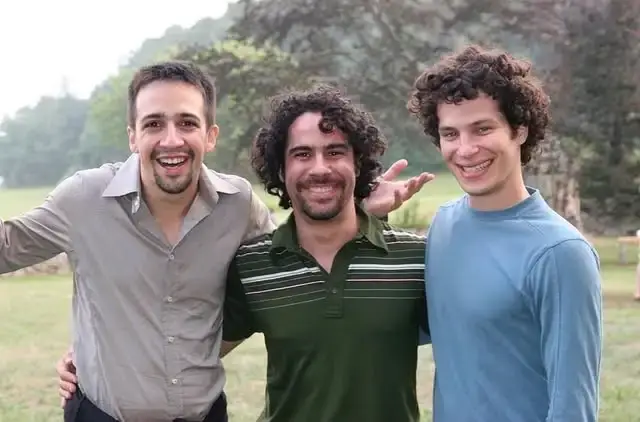 Lin-Manuel Miranda, Alex Lacamoire, and Thomas Kail smile together outdoors during the 2005 development of In the Heights.