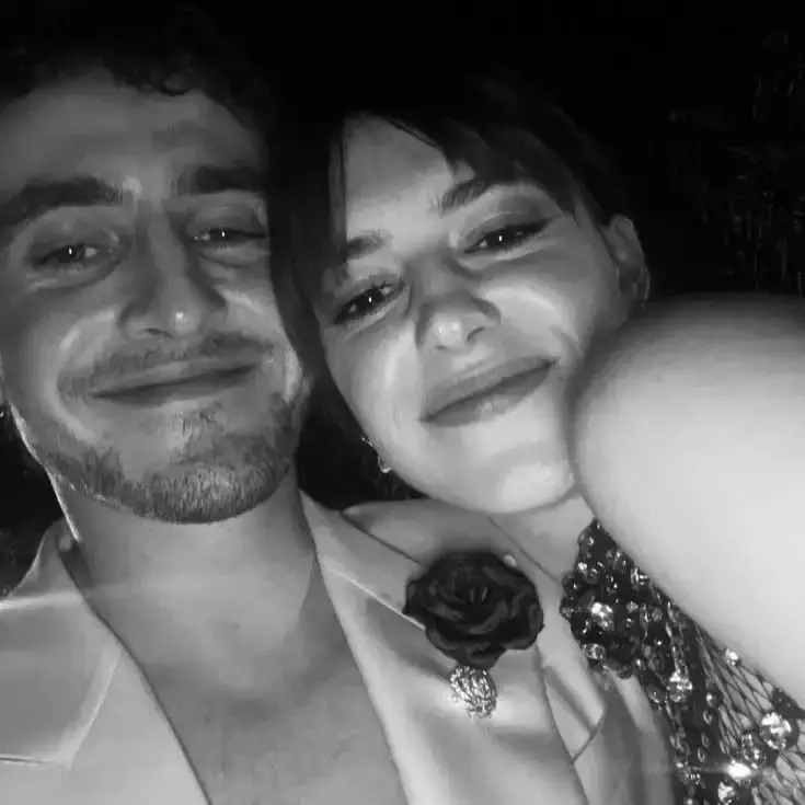 A close-up black and white selfie of Paul Mescal and Daisy Edgar-Jones smiling warmly at each other.