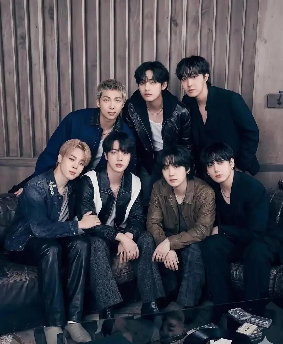 All seven members of BTS sitting and standing together