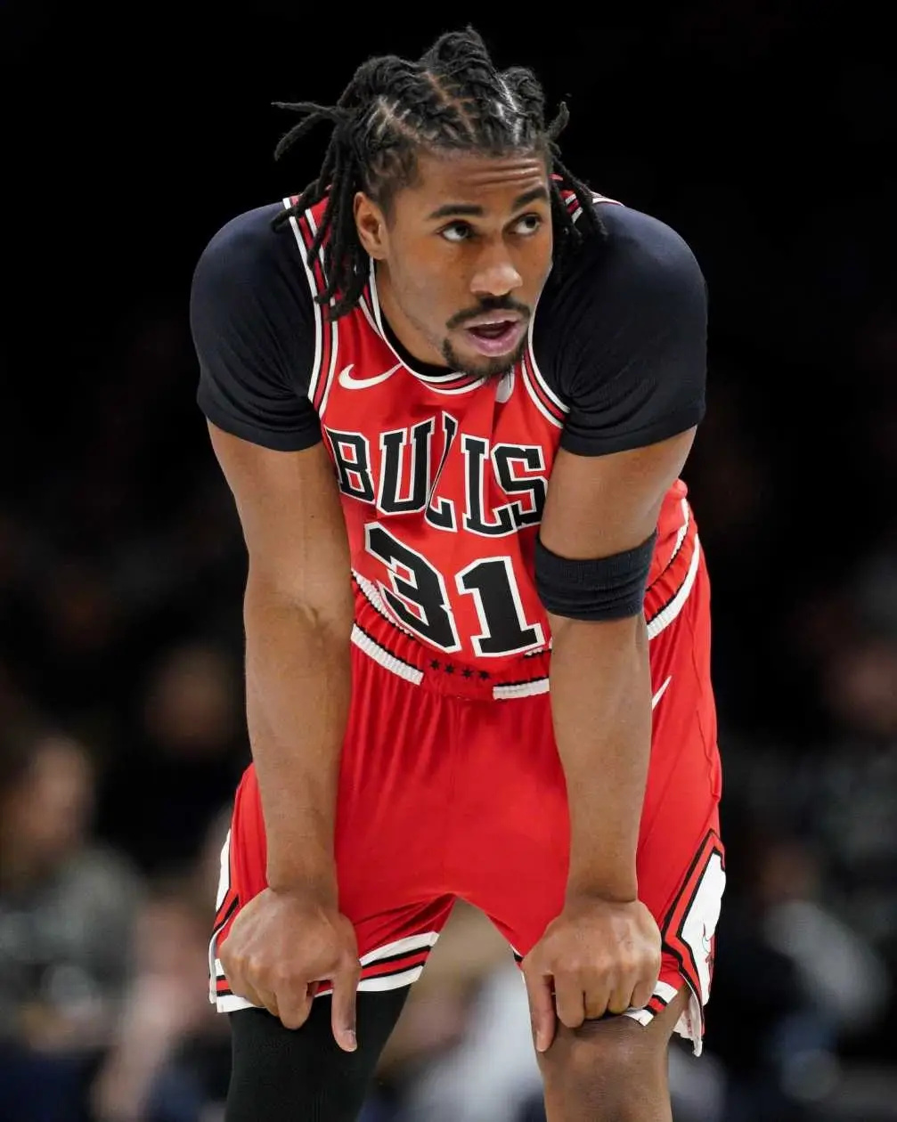 Jadan Levy leans forward on the court wearing a red Chicago Bulls jerse.