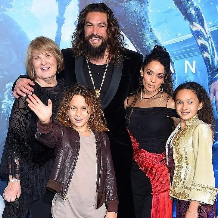 Jason Momoa and Lisa Bonet stand with their children, Nakoa-Wolf Momoa and Lola Iolani, and grandmother Coni Momoa at a red-carpet event.