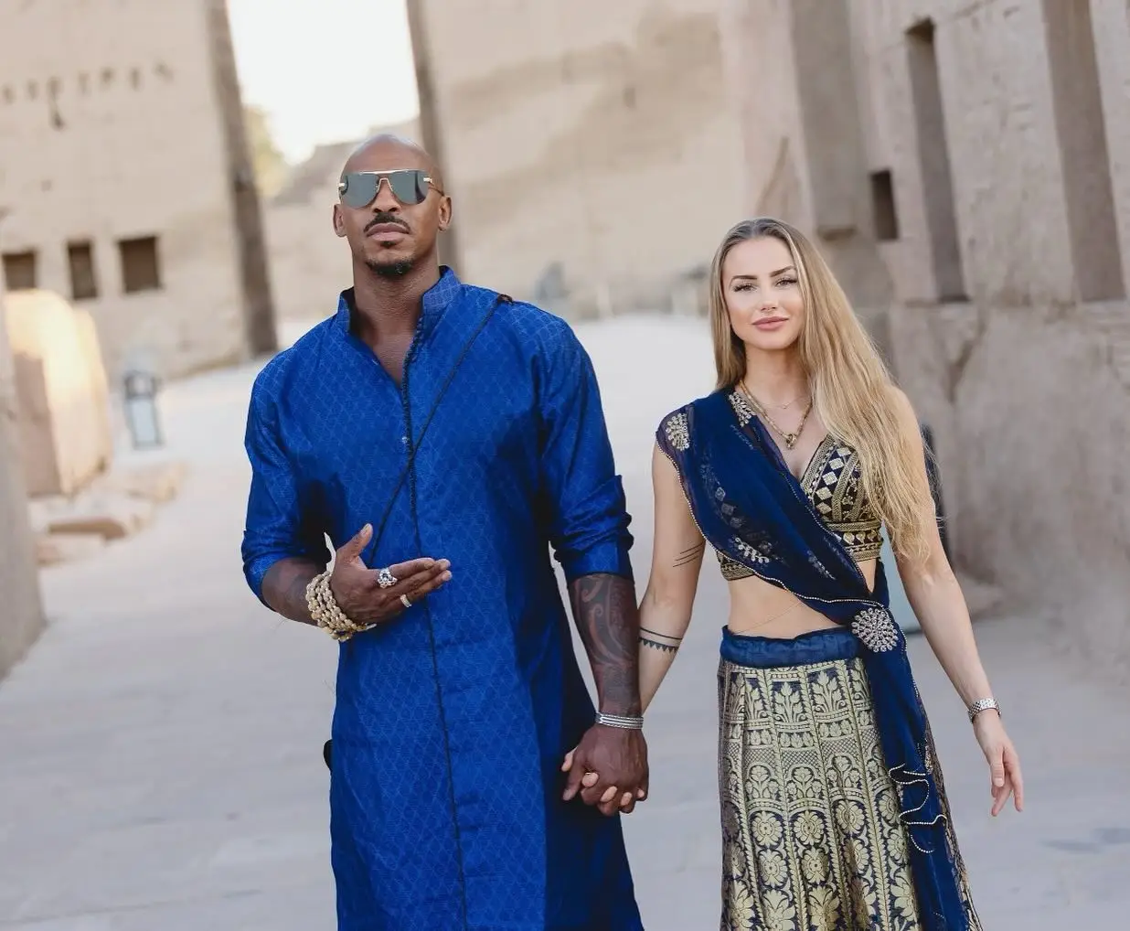 Mehcad Brooks and Frida Brooks hold hands.