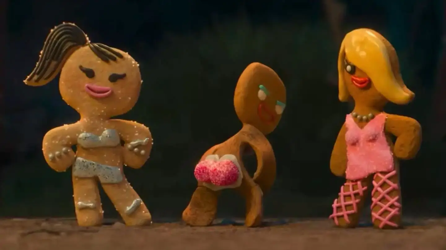 An animated scene from the Shrek 5 teaser showing three female gingerbread cookies watching the Gingerbread Man twerk with sugar-dusted, pink gumdrop buttocks.