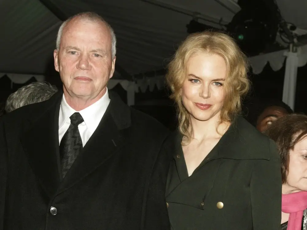 Actress Nicole Kidman poses beside her late father, Dr. Antony Kidman, who is dressed in a black suit and tie at an evening event.