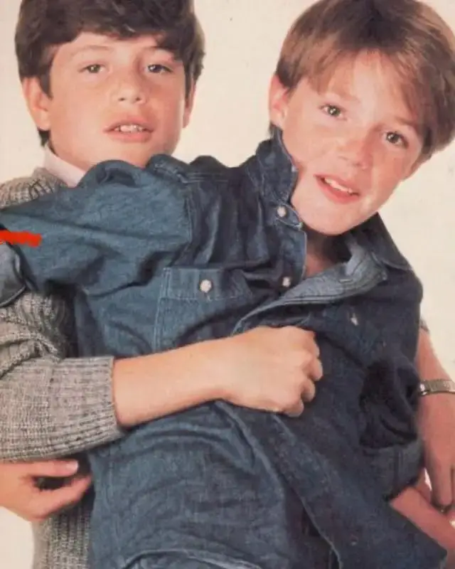 Young Sean Astin holding his younger brother MacKenzie Alexander Astin in a playful embrace.
