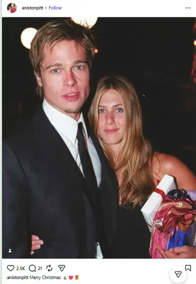 Brad Pitt in a suit and tie standing close to Jennifer Aniston as she holds wrapped holiday gift boxes.
