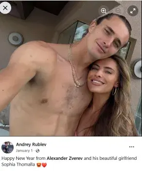 Shirtless Alexander Zverev smiling in a sunny outdoor selfie alongside his girlfriend Sophia Thomalla.