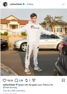 Nathan Fielder posing with arms outstretched in a white Summit Ice sweatsuit in a suburban driveway.