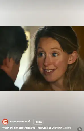 Close-up shot of Elizabeth Holmes smiling with wide eyes in a scene from a teaser trailer.