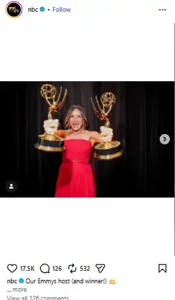 Mariska Hargitay cheering in an elegant strapless red gown while holding up two Emmy Award statuettes.