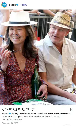 Laura Louie in a patterned red dress and white fedora smiling beside Woody Harrelson wearing a straw hat.