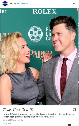 Scarlett Johansson resting her hand on Colin Jost