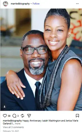 Isaiah Washington in glasses and a dark suit smiling warmly as his wife Jenisa Marie Garland wraps her arms around his shoulder.