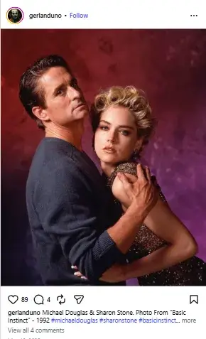 Sharon Stone in a sparkling sleeveless dress resting close against Michael Douglas in a dark sweater against a moody purple-red backdrop.
