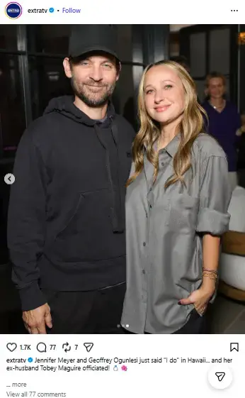 Tobey Maguire in a black hoodie and baseball cap smiling alongside jewelry designer Jennifer Meyer in an oversized grey shirt.