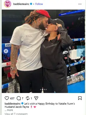 Natalie Nunn sharing a kiss with her husband Jacob Payne ringside next to a boxing ring.
