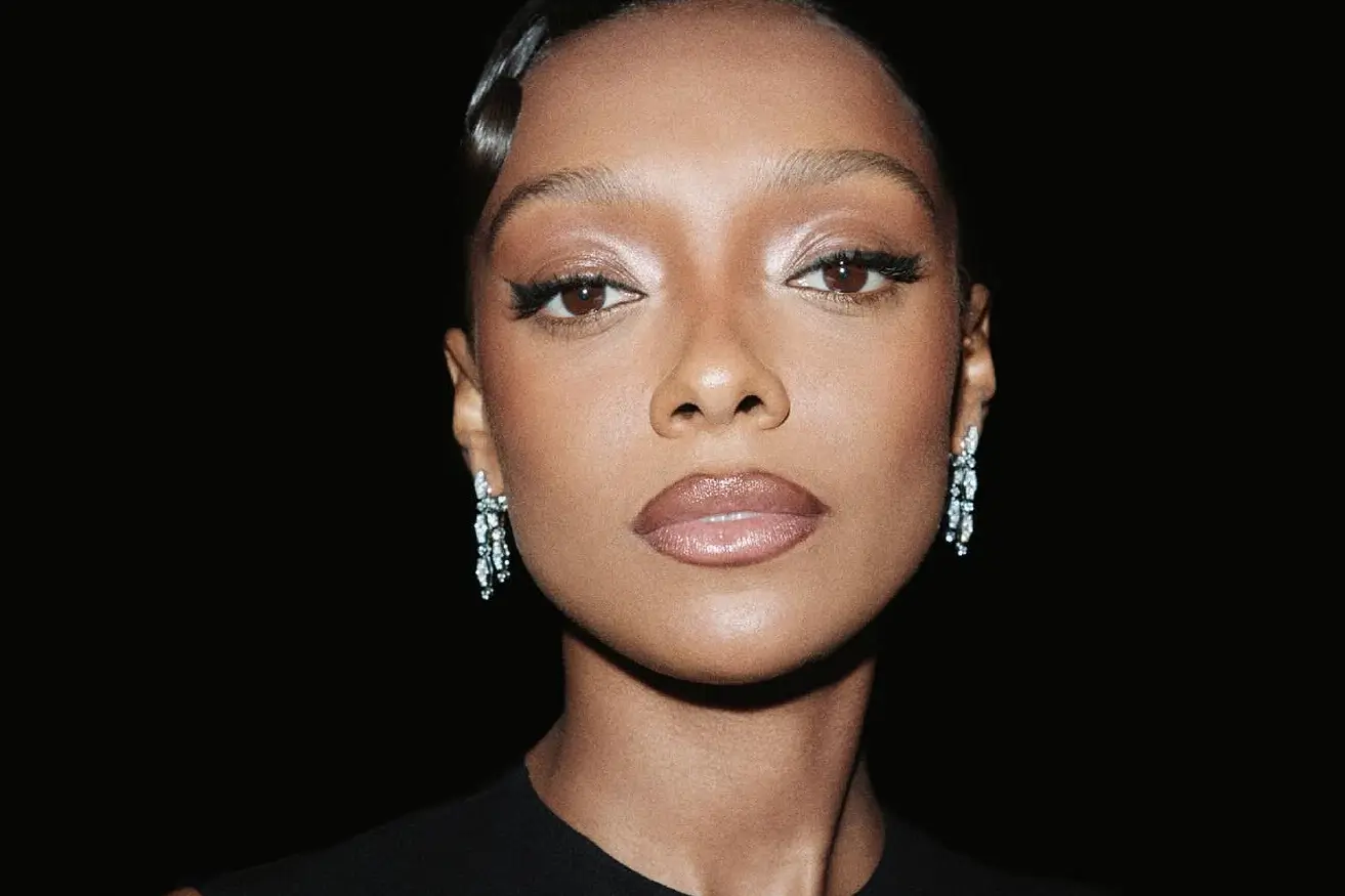 Sophie Wilde, with her hair slicked back and wearing shimmering eye makeup.