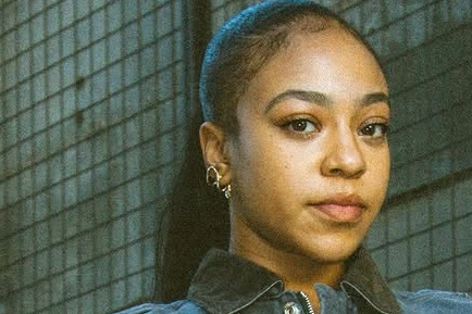 A close-up of Priah Ferguson, wearing gold earrings.