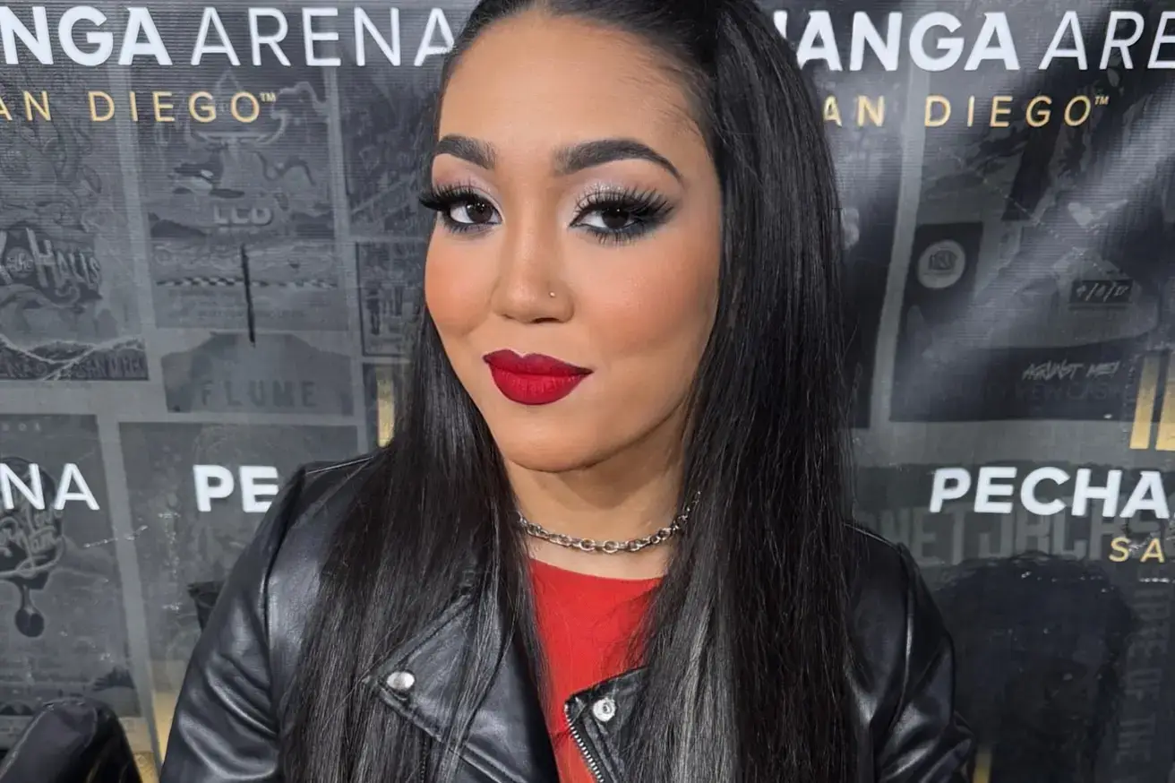 Roxanne Perez wearing a black leather jacket and a silver chain necklace.