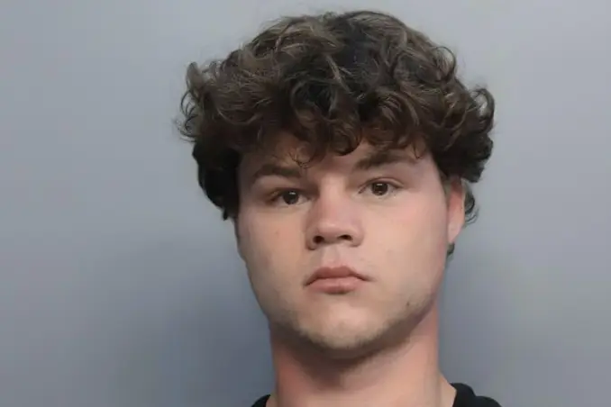Jack Doherty with messy, dark curly hair, looking serious.