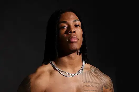 Close-up portrait of the shirtless football player Jahmyr Gibbs