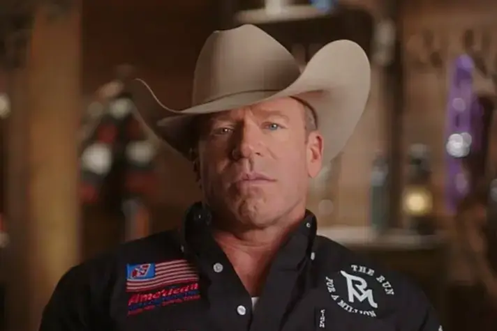 Taylor Sheridan wearing a light-colored cowboy hat.