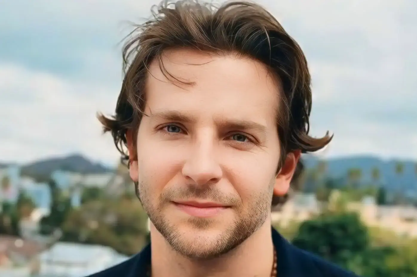 Bradley Cooper with light stubble and wind-blown hair
