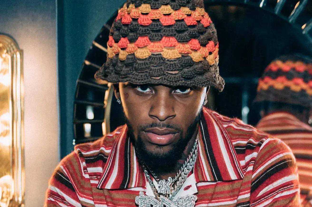 Rapper Toosii looking intensely at the camera.