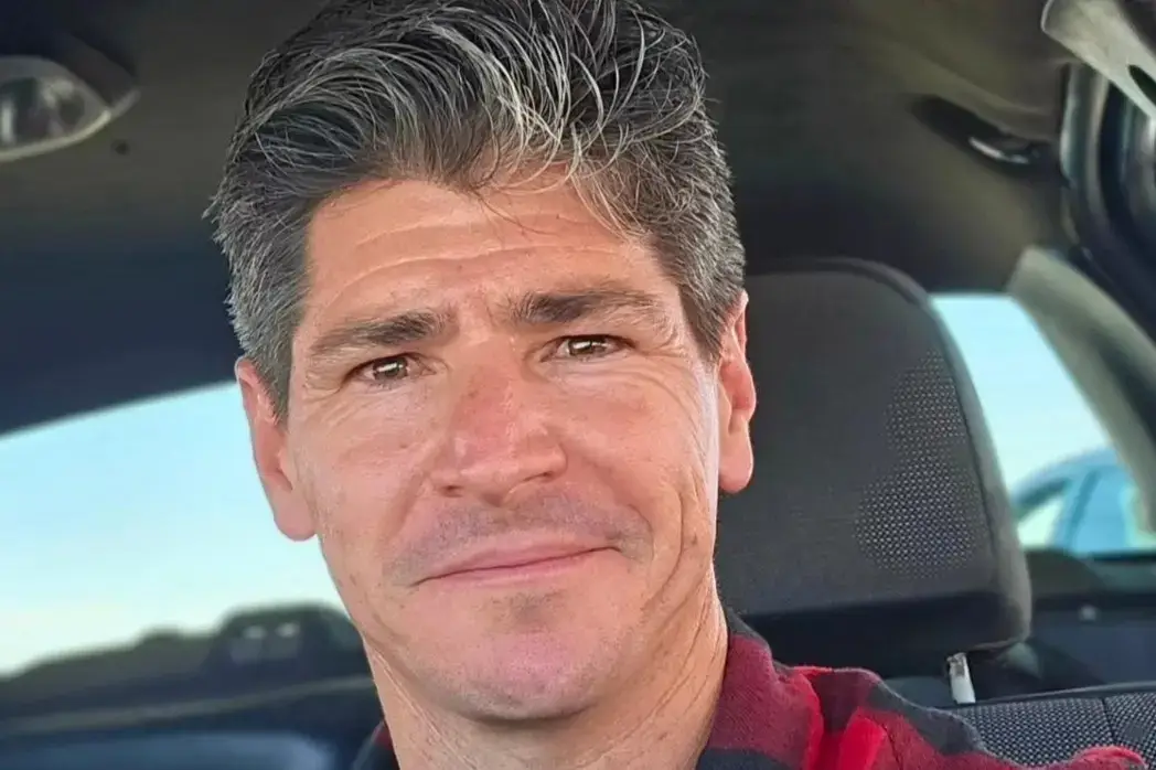 Michael Fishman smiling closely at the camera