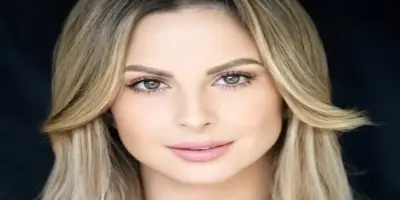 A professional headshot of Harley Cameron, with a slight smile and her long blonde hair styled to fr