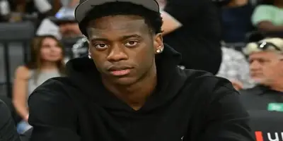 A.J. Dybantsa wearing a black hoodie and white cap.