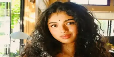 Close up portrait of Avantika Vandanapu with curly hair and a bindi.